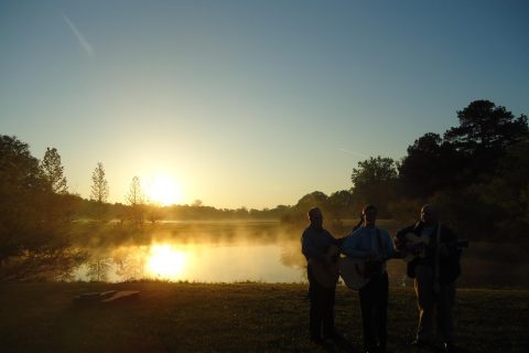 People singing at a lake