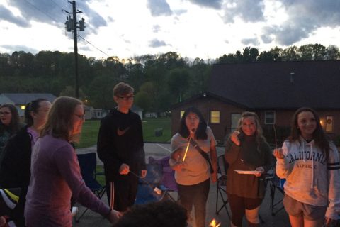 Teenagers around a campfire