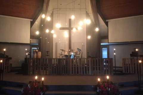 Church alter with lights and wreaths set for Christmas service