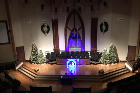 Glendale Christian Church sanctuary dark with lighting on the stage for Christmas