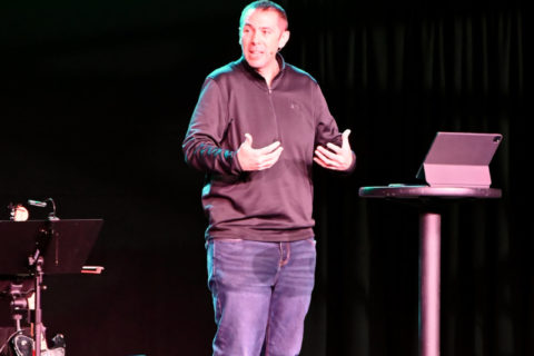Pastor preaching on a stage