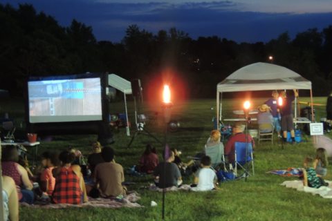 people gather for a outside movie night