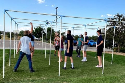 Kids play nine square a game where you hit a ball over nine pipes connected to each other