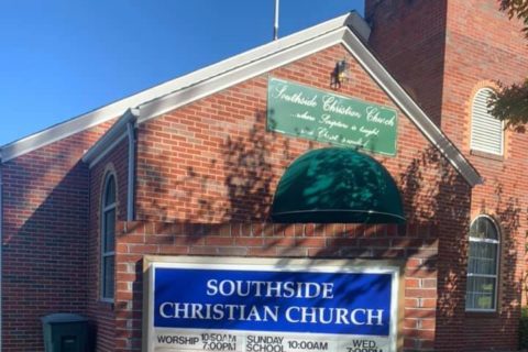 A church sign reads, 