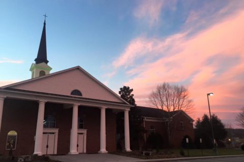 Photo of church building and sunset