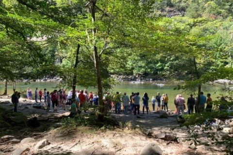 Love Chapel Church - A group of people lined up in front of a river