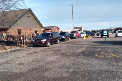 Newton Christian Church - cars line up in front of the church building for a food drive.