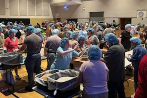 Crossroads Kansas Christian Church: people gather meals and materials for a service project