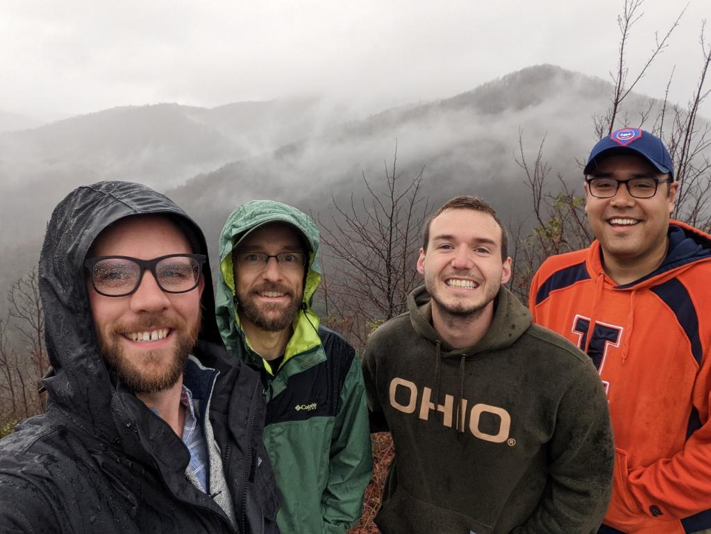 Four young men hiking with a mountain in the background(1)